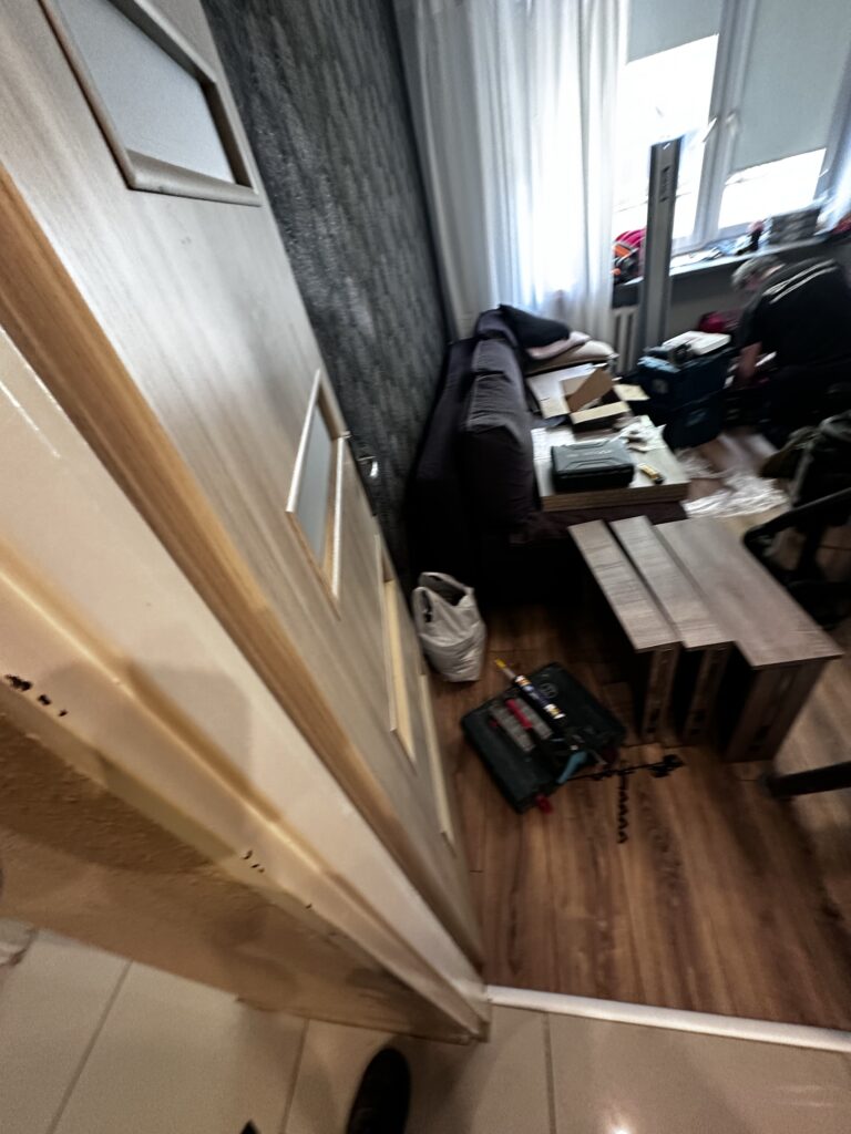 Stół roboczy i narzędzia w wąskim pokoju.